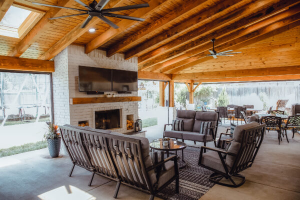 Large custom pergola with fireplace and seating area