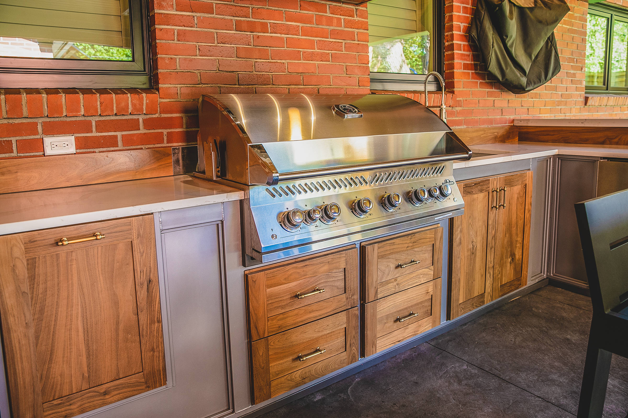 Outdoor kitchen with grill and cabinets